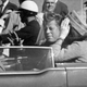 President John F. Kennedy approximately one minute before he was shot in Dallas. Image via AP.